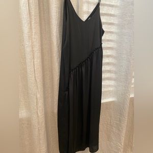 Satin black spaghetti strap dress with ruffle front asymmetrical detail. Small